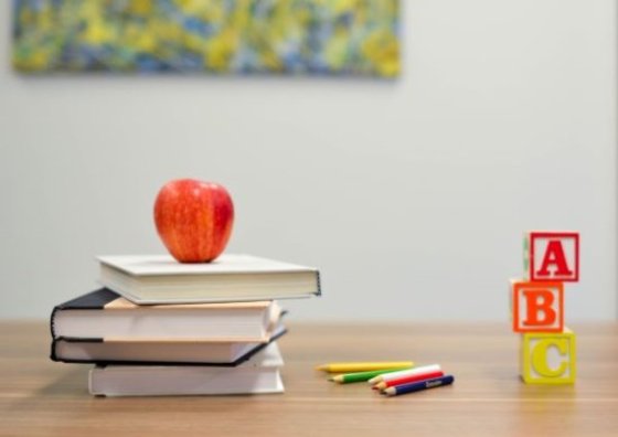 Bücher mit Apfel auf Tisch